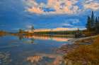 Canada-Ontario-Kenora District Forest autumn colors reflect on Middle Lake at sunrise Art Print
